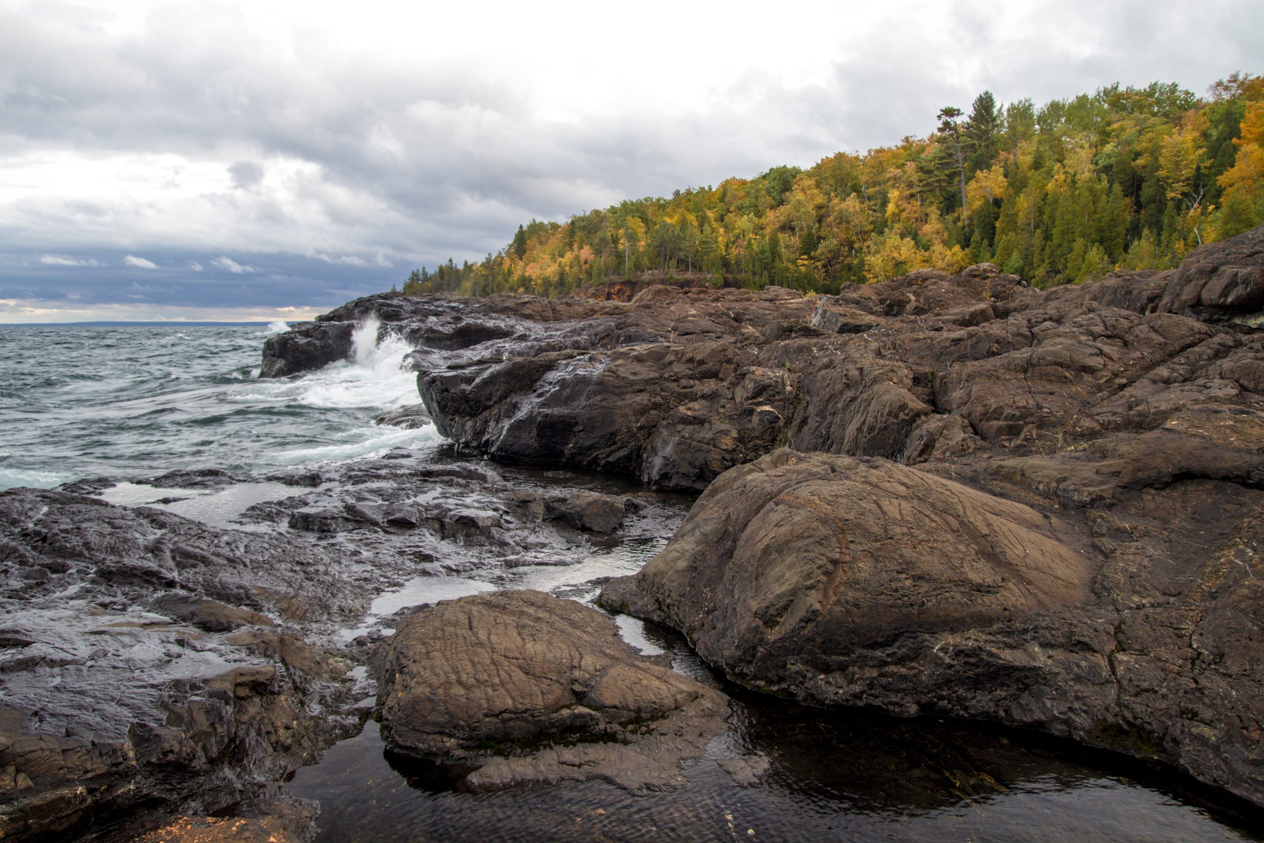 Waves Crash On Lake Superior Coast. Waves crash on rocky coast of Lake Superior at Presque Isle Park in Marquette, Michigan.